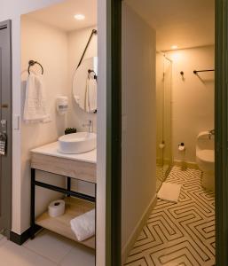 a bathroom with a sink and a shower at Hotel Principe in Tuluá