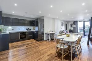 cocina y comedor con mesa y sillas en 3 Bedrooms Close to Canning Town & ExCel London en Londres