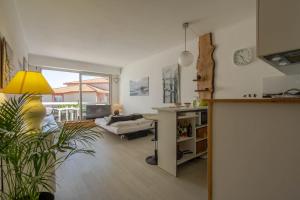 a living room with a table and a yellow lamp at Studio vue sur l'océan in Anglet