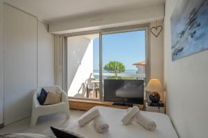 a bedroom with a large window with a view of the ocean at Studio vue sur l'océan in Anglet