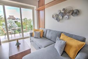 a living room with a couch and a table at Pavilion 2BR Golden Zone - 1 Block to Beach in Bucerías