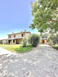 a large house with a driveway in front of it at La Casetta in Orvieto Scalo