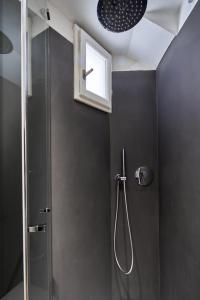 a bathroom with a shower with a glass door at Casa Monelli in Siena