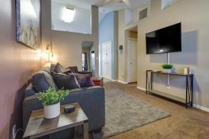 a living room with a couch and a tv at Clermont Vacation Rental with Community Pool! in Clermont