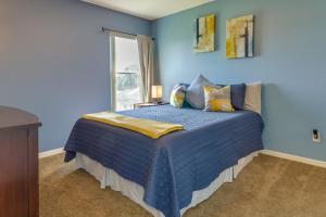 a blue bedroom with a bed and a window at Clermont Vacation Rental with Community Pool! in Clermont