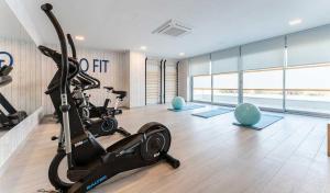 a gym with a treadmill and a exercise bike at ÁTICOS ROTA Punta Candor in Rota
