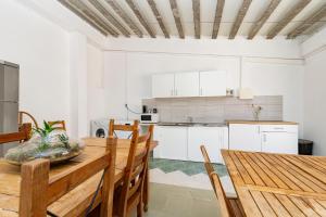 a kitchen and dining room with a wooden table and chairs at Solar Santo Antonio in Palmela