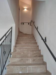 a staircase in a house with a stair railing at La casetta della Pigna Verde in Marsala
