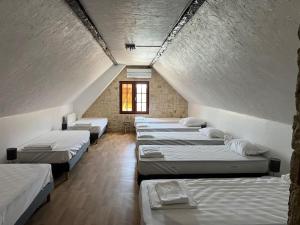 a row of beds in a room with a window at La clé des champs - Les Grais 1H10 de Paris in Bazoches-sur-le-Betz +34 photos