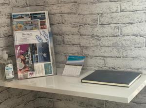 a white table with a book and magazines on it at Seasgair House in Balivanich