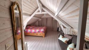 una camera da letto mansardata con letto e specchio di Maisonnette à Saint Valéry Sur Somme a Saint-Valéry-sur-Somme