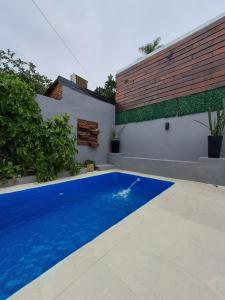 a swimming pool in the backyard of a house at Casa Blanca Posadas in Posadas