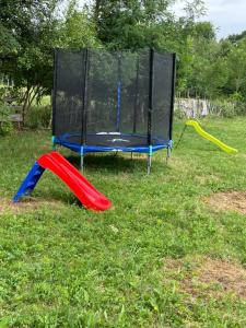 a playset in a field of grass with a slide at STORY GLAMPING POLOVRAGI in Racoviţa