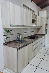 a kitchen with a sink and a counter top at Casa Blanca Posadas in Posadas