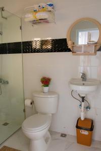 a bathroom with a toilet and a sink at Royal Terrace III (Prince) in San Felipe de Puerto Plata