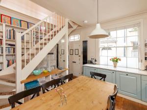a kitchen with a dining room table and a staircase at Pass the Keys Luxury City Centre House in Bath