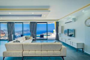 a living room with a couch and views of the ocean at Hadi Villa in Kalkan