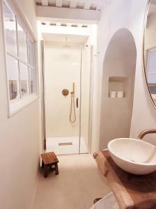 a bathroom with a sink and a shower at Casa Concha Apartamentos in Calella de Palafrugell