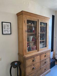 a wooden cabinet with dishes in it in a room at Porte de Paris - Saint-Denis quartier historique in Saint-Denis