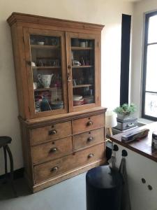 a wooden cabinet in a room with a desk at Porte de Paris - Saint-Denis quartier historique in Saint-Denis