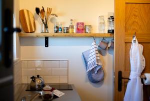 a kitchen with a sink and a counter top at Daisy Bank Camp in Hebden Bridge