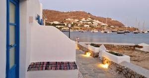 a white building with lights on the side of a beach at Absolute Water Front properties by Blue Waters Mykonos in Ornos
