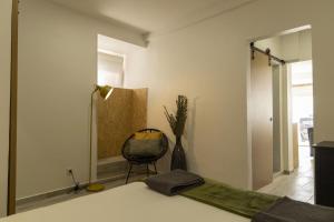 a room with a bed and a chair and a mirror at Seixal Bay Apartments in Arrentela +105 photos
