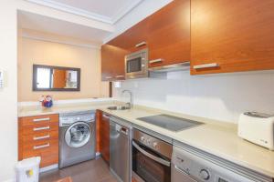 a kitchen with a washing machine and a washer at Apartamentos Verdemar (VUT) in Llanes