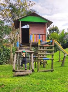 a young boy is sitting on a playground at Apartasol confortable cerca al parque del café! in La Tebaida