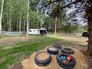 a group of tires sitting on the ground next to a tent at Viršu Glempings in Engure