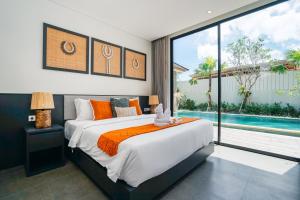 a bedroom with a large bed and a swimming pool at Villa Bunga Lily - Sumptuous 3BR Luxury Private Villa in Canggu in Canggu