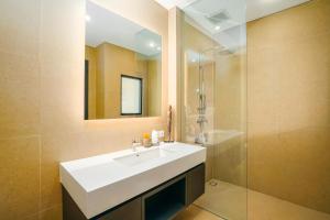 a bathroom with a white sink and a shower at Villa Bunga Lily - Sumptuous 3BR Luxury Private Villa in Canggu in Canggu +29 photos