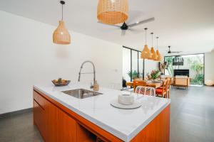 a kitchen with a sink and a counter top at Villa Bunga Lily - Sumptuous 3BR Luxury Private Villa in Canggu in Canggu