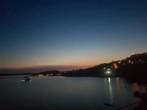 a river at night with a boat in the water at 1 Bed Flat - Sleeps 2 - Parking - Wifi in Zubovići +2 photos