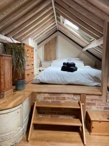 a bedroom with a bed in an attic at The Arches - Private woods, comfy beds, fast Wi-Fi, SkyNetflix in Wellingborough