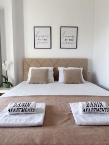 a bedroom with a bed with two pillows on it at Danin apartmani in Bar