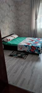 a bed sitting on the floor in a bedroom at Casa Rebeca in Orşova