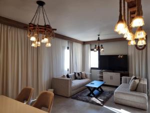 a living room with a couch and a table at Fanadir Marina Elgouna villa in Hurghada