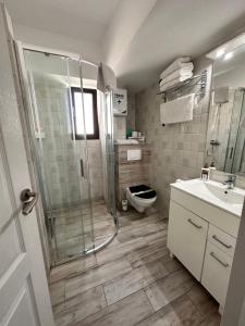 a bathroom with a shower and a toilet and a sink at Rohan Studio One in Mamaia Nord