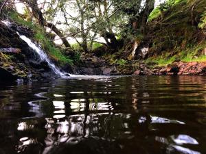 a waterfall in the middle of a river at Glyndwr Bell Tent in Builth Wells