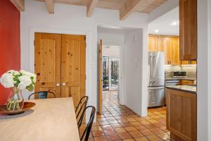 a kitchen with a table and chairs and a refrigerator at Casa Anita in Santa Fe