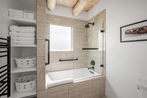 a bathroom with a tub and a glass shower at Casa Anita in Santa Fe