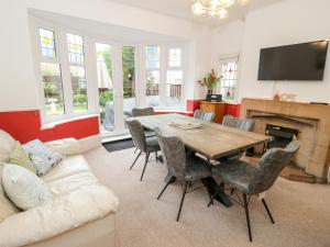 a living room with a table and a couch at Beausite in Colwyn Bay