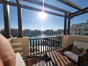 a balcony with a view of a body of water at Fanadir Marina Elgouna villa in Hurghada