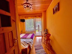 a bedroom with a bed and a window at Turbacz pokoje gościnne in Ochotnica Górna