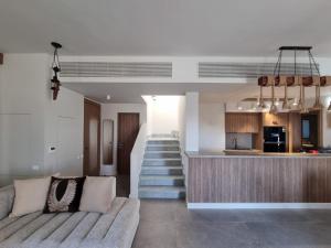 a living room with a couch and a kitchen at Fanadir Marina Elgouna villa in Hurghada