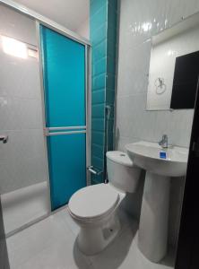 a bathroom with a toilet and a sink and a shower at Apartahotel Eden Coveñas in Coveñas