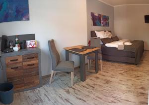 a room with a bed and a desk and a bed and a bedroom at Schlafort in Porta Westfalica