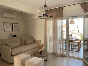 a living room with a couch and a table at Morpheus boutique apartment in Preveza