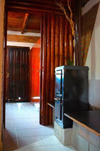 a kitchen with a counter and a door to a room at Sierras Cabañas in Villa Carlos Paz